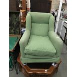 A green fabric covered arm chair