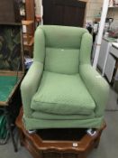 A green fabric covered arm chair