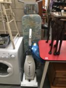 An Electrolux Powerlite pet hoover and an ironing board