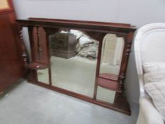 A mahogany over mantel mirror.