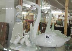 A large Lladro swan, a NAO geese study and a NAO figure of a girl with puppy.