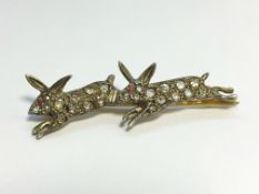 An old cut diamond brooch fashioned as 2 running rabbits.