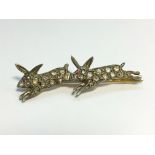 An old cut diamond brooch fashioned as 2 running rabbits.