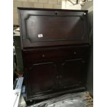 A dark wood stained bureau