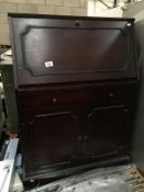 A dark wood stained bureau