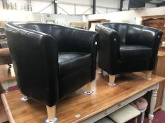 A pair of leather tub chairs