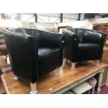 A pair of leather tub chairs