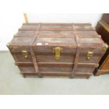 A large wood bound cabin trunk.