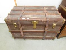 A large wood bound cabin trunk.