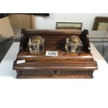 An Edwardian oak inkstand complete with glass inkwells.