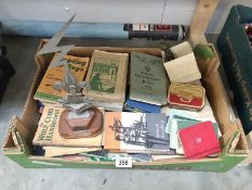 A box of Scouts and scouting memorabilia and books.