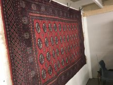 A large red patterned Eastern acrpet approximately 245cm x 164cm