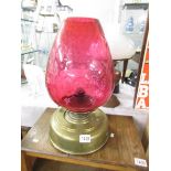 A brass oil lamp with cranberry shade, a/f.