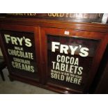 A glazed cupboard with stencilled lettering to doors.