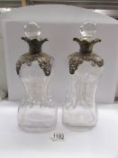 A pair of 19th century glass decanters with metal mounts.