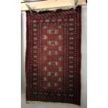 A small red patterned Eastern rug approximately 160cm x 95.