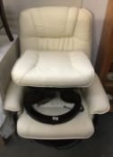 A leather massage chair with stool.