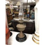 A brass oil lamp complete with chimney.