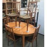 A teak dining table and 6 chairs.