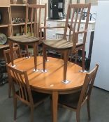 A teak dining table and 6 chairs.