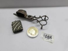 A St. George medallion, a vesta case and snuffer scissors.