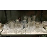 A shelf of glassware including vases, bowls, jugs etc.