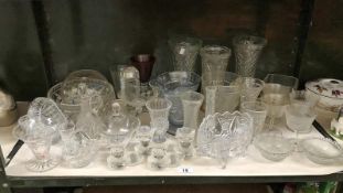 A shelf of glassware including vases, bowls, jugs etc.