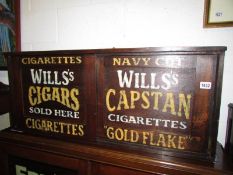 An oak cupboard with stencilled lettering to doors.