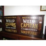 An oak cupboard with stencilled lettering to doors.