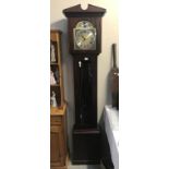 A modern dark wood stained tempus fugit grandfather clock.
