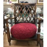 A child's armchair with pouffe seat.