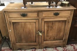 A stripped wood side cabinet.