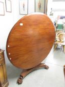 A Victorian mahogany circular tip top table.