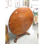 A Victorian mahogany circular tip top table.