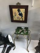 A tiled top trivet and a framed bird tile.