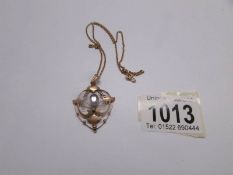 An Edwardian gold pendant on chain.