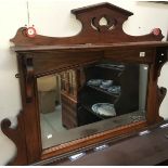 A mahogany over mantel mirror.