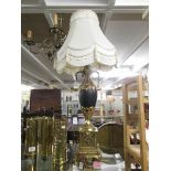 An urn shaped table lamp with gilding and complete with shade.