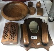 A 1930s oak wall mirror brush set and other treen items.