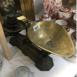 A set of vintage cast iron scales with brass pans including weights.