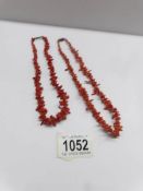2 coral necklaces.