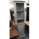 A shabby chic painted corner cupboard.