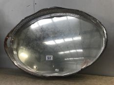 A large oval silver plate on copper gallery tray.