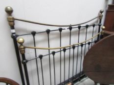A brass and iron bedstead complete with slats.