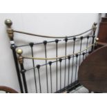 A brass and iron bedstead complete with slats.