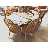 A set of 6 light Ercol dining chairs.
