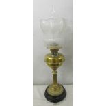A Victorian brass column oil lamp with original acid etched tulip shade. (slight nibble to rim).