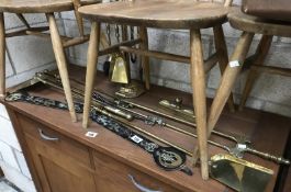 A quantity of Victorian brass fire irons and a companion set.