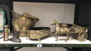 A shelf of brassware including horse and cart, coal scuttle etc.