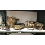 A shelf of brassware including horse and cart, coal scuttle etc.